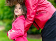 pretty little girl in the arms of his mother