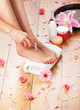 Spa background with a beautiful legs, flowers and petals