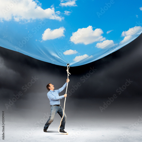 Photo: Businessman pulling banner Businessman pulling banner
