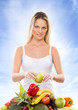 Foto: Young attractive girl with a pile of fruits and vegetables isola Young attractive girl with a pile of fruits and vegetables isola