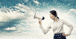 Businesswoman screaming in megaphone