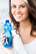 Woman with bottle of water, at fitness club
