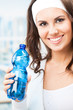 Woman with bottle of water, at fitness club