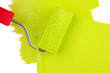 Paint roller brush with green paint, on wooden background