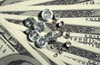 Beautiful shining crystals (diamonds) on money background