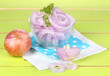 Onion cut with rings in bowl on wooden table close-up