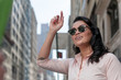 Cute woman hails taxi in NYC