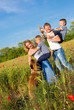 Foto: Family playing on the meadow Family playing on the meadow