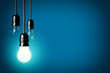 idea concept with broken bulbs and one glowing bulb