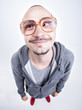 funny man with big glasses cross looking and smiling