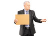 Broken businessman holding a piece of cardboard and begging