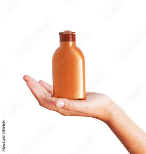 Photo: Hand holding plastic bottle for sun lotion isolated on white bac Hand holding plastic bottle for sun lotion isolated on white bac