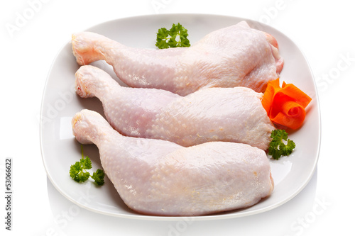 Photo: Raw chicken legs on white background Raw chicken legs on white background