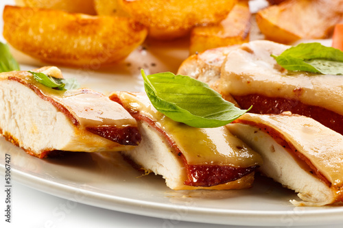 Photo: Grilled chicken breasts with cheese and baked potatoes Grilled chicken breasts with cheese and baked potatoes