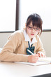 young asian school girl studying