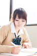 a young asian school girl studying