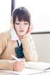 a young asian school girl studying