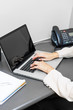 Hands typing on laptop keyboard