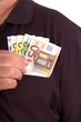 Man pushes money into his breast pocket