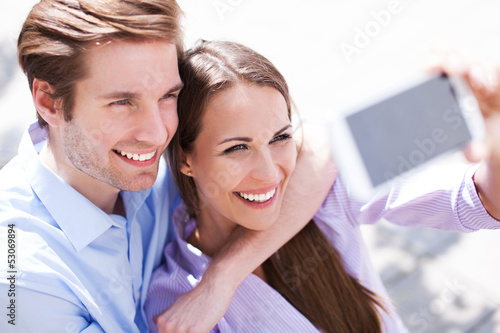 Photo: Couple taking photo of themselves Couple taking photo of themselves