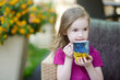 Adorable little girl drinking hot chocolate
