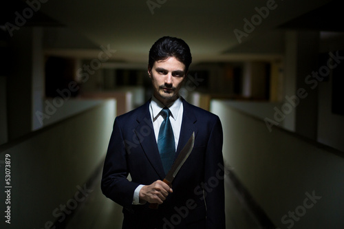 Photo: The killer in a suit with a knife The killer in a suit with a knife