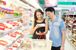 couple buys meat at the supermarket