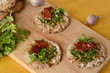 Snacks sandwiches with pesto and sun-dried tomato on rye cakes