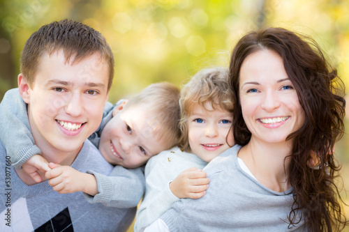 Photo: Happy family in autumn park Happy family in autumn park
