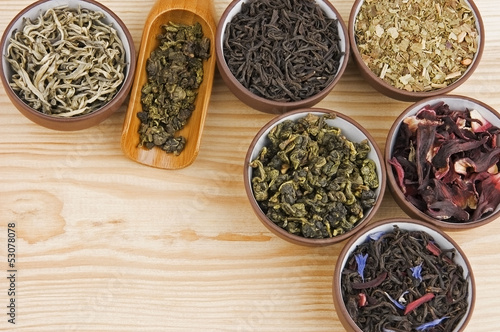 Photo: Assortment of dry tea in ceramic bowls Assortment of dry tea in ceramic bowls