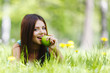 Woman with apple outdoors