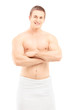 Smiling young man in towel posing after shower