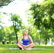 Young female meditating in a park