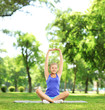 Young woman exercising in a park on a sunny day