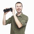 young man looking with binoculars, cheerful face expression