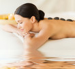 woman in spa with hot stones