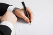 businessman writing something on the paper