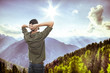 young man on top of the mountain, realxing and enjoying the view