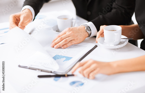 Photo: woman hand signing contract paper woman hand signing contract paper