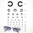 Table for eye tests with glasses on white background