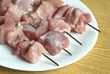 Raw sliced barbecue on white plate closeup