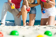 Foto: Man and women playing boule on beach Man and women playing boule on beach