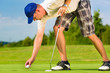 Photo: Young golf player on course putting Young golf player on course putting