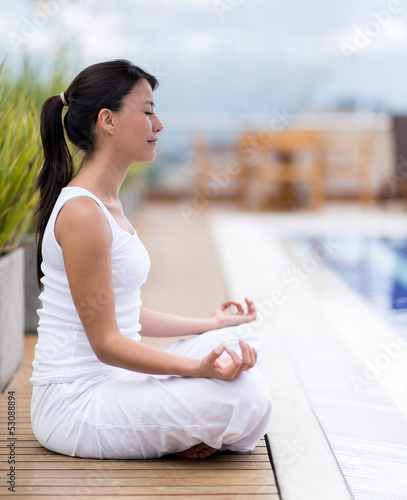 Photo: Woman meditating outdoors Woman meditating outdoors