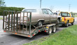 Photo: Cadillac on a flatbed and towed by yellow truck Cadillac on a flatbed and towed by yellow truck