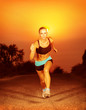 Photo: Sporty woman running on sunset Sporty woman running on sunset