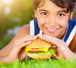 Happy boy eating burger