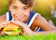 Pretty boy eat burger outdoors
