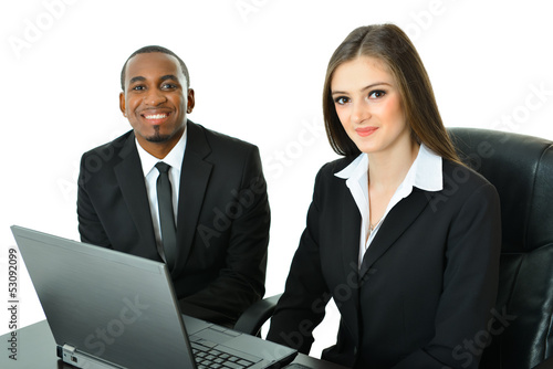 Photo: Two Co-Workers Sitting and Working Two Co-Workers Sitting and Working