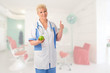 Mature doctor with green apple shows ok gesture